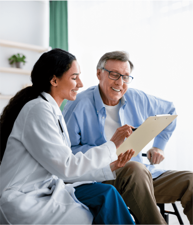 doctor talking with old woman in her house